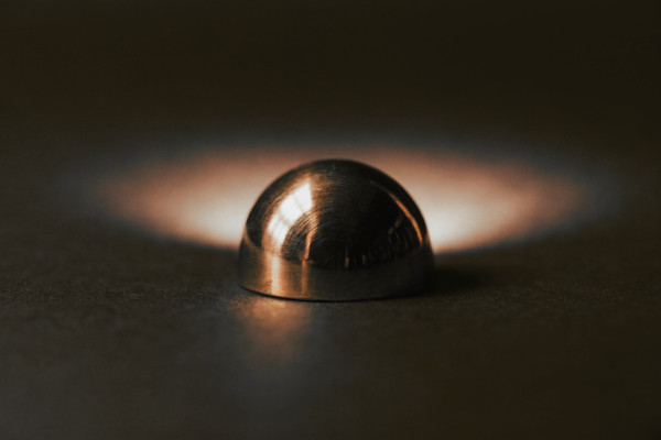 A polished brass scale weight